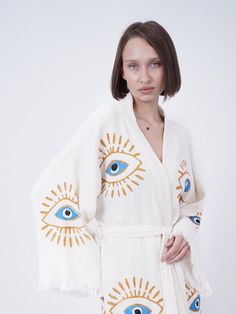 Introducing our exquisite organic cotton Handmade Evil Eye Boho Festival Kimono, a mesmerizing blend of bohemian elegance and spiritual symbolism. Handcrafted with love and care, this kimono is a stunning addition to your festival wardrobe, offering both style and positive energy. Our bohemian kimono, which is made of 100% handmade high quality cotton fabric, can be used as a pareo in daily life or on the beach. (Made in Turkey) All of our ultra soft products are OEKO-TEX Standard 100 Certified. Bohemian V-neck Cardigan For Loungewear, Folk Style Cotton Kimono For Spring, Bohemian Cotton Cardigan For Loungewear, White Cotton Cardigan For Vacation, White Long Sleeve Relaxed Fit Kimono, Beach Cotton V-neck Cardigan, Beach V-neck Cotton Cardigan, Summer Festival Cotton Cardigan, Cotton Summer Festival Cardigan