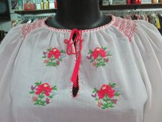 "Beautiful vintage flared etnic blouse. Maybe hungarian or romanian from the 60s. White cotton fabric. Delicious floral hand embroideries on front and sleeves. The colour of the flowers is pink/red. Round keyhole neckline that closes with a stripe (pic.2). Raglan sleeves. Cute flared short sleeves with darts and embroideries (pic.3). Boho/hippy style. Mint conditions. It fits size S-M Measurements: (lay flat and double chest) Shoulders up to 15.7\" chest 36.2\" sleeve length (from neck bottom to Spring Folk Blouse With Woven Motifs, Spring Short Sleeve Blouse With Boho Collar, Spring Folk Blouse With Yoke, Folk Style Blouse With Woven Motifs For Festivals, Traditional Spring Peasant Top With Yoke, Bohemian Tops With Traditional Patterns For Summer, Traditional Short Sleeve Tops With Motif, Bohemian Embroidered Short Sleeve Peasant Top, Traditional Spring Blouse With Boho Collar