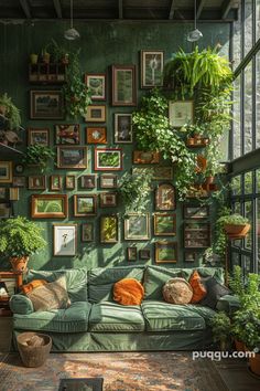 a living room filled with lots of plants and framed pictures on the wall above it