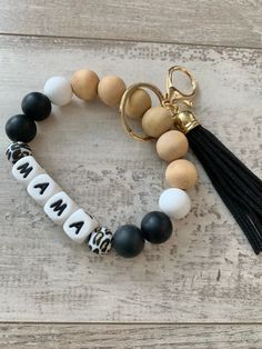 a black and white beaded bracelet with the word mama on it