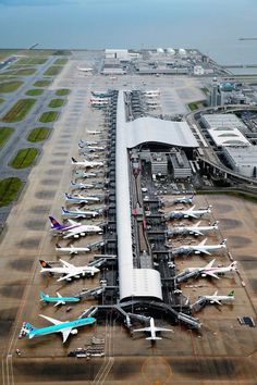 an airport filled with lots of airplanes parked next to each other