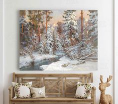 a painting hanging on the wall above a wooden bench with pillows and deer figurines