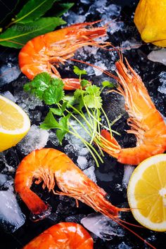 shrimp and lemons on ice with garnish