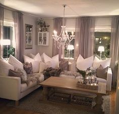 a living room filled with furniture and a chandelier