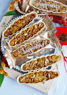 some kind of food sitting on top of a wooden tray next to other foods and decorations