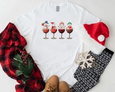 three wine glasses with santa hats on them