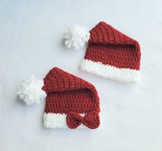 two crocheted hats with white and red trim