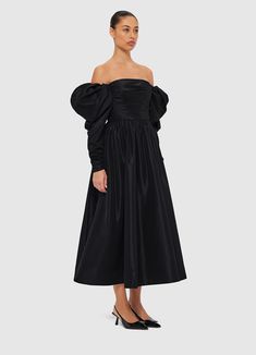 PRODUCT DESCRIPTION Premium off-shoulder gownStrapless necklineZipper detail necklineFitted ruched bodiceGathered puff sleeveElastic shoulderRuched zip cuff openingInvisible back zip closurePleated A-line silhouetteFully lined SIZE & FIT 6 8 10 12 14 16 Collar 77.5 82.5 87.5 92.5 98.5 104.5 Bust 80 85 90 95 101 107 Waist 67 72 77 82 88 94 Sleeve Length 47 47 47 47 47 47 Sleeve Opening 18.5 19.5 20.5 21.5 22.5 23.5 Back Length 109.8 111 112.2 113.4 114.6 114.6 Hem Circumference 471 475 479 483 487 494 Model is 5’10” (178 cm) and wears a size 8Bust: 31.5” (80cm) / Waist: 24” (61cm) / Hips: 36” (91cm) Cocktail Off-shoulder Dress With Gathered Sleeves, Voluminous Ruched Puff Sleeve Dress For Party, Voluminous Ruched Puff Sleeve Party Dress, Evening Dresses With Ruched Voluminous Skirt, Black Ruched Off Shoulder Dress For Evening, Black Ruched Off Shoulder Evening Dress, Evening Dress With Gathered Neckline And Long Sleeves, Elegant Off Shoulder Puff Sleeve Dress For Evening, Chic Off Shoulder Dress With Ruched Bodice