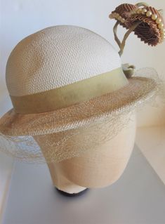 "Crazy cute off white panama straw hat from the 1930's with two jutting brown fabric florals on green stalks trimmed in faux pearls. The hat measures 20\" on the inside circumference and the crown of the hat is about 4\" high. Each flower measures 2\" in diameter and they stand up about 3\". It has a grosgrain ribbon bow. The hat is in great condition for its age with only tearing of the netting and some soiling of the inside rim. It is marked \" Genuine Panama\" on the inside band. Please email Vintage Fitted Brown Panama Hat, Fitted Vintage Brown Panama Hat, Fitted Cream Hat Bands, Fitted Retro Cream Hat, Cream Brimmed Hat Bands For Kentucky Derby, Vintage Brown Wide Brim Panama Hat, Vintage Brown Adjustable Panama Hat, Retro Fitted Cream Hat, Retro Cream Hat