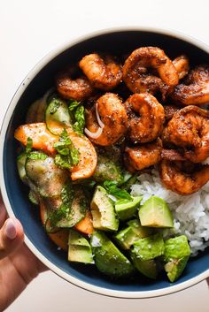 a bowl filled with rice, shrimp and avocado