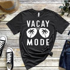 Black Graphic Print T-shirt For Vacation, Black Crew Neck Top For Vacation, Vacation Graphic Tee With Text Print, Vacation Graphic Tee With Crew Neck, Graphic Tee With Screen Print For Vacation, Vacation Graphic Tee Shirt, Vacation T-shirt With Text Print And Relaxed Fit, Vacation Relaxed Fit T-shirt With Text Print, Vacation Text Print Relaxed Fit T-shirt