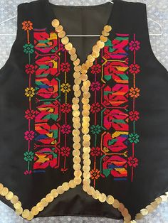 This is a Vintage Style Egyptian Arabic Bedouin Vest Hand Embroidered with Colorful Gorgeous Canvas and coins all over it   Look at the Stunning Bedouin Tribal Work with heavy brass Gold CoinsLovely Handmade and crafted of Siwa Egypt. This Vest is in in never worn new condition.   Its length : 23" -Around Hip : 22" Bust 19"-approximately One Size which can fit most sizes. It's a double layered vest made of high quality material (inner layer is Silk)     Amazing Really a piece of Artyou will be impressed by it's Stunning Vintage stitches and Heavy Coins along with Bedouin Style.   Very nice Ethnic Bedouin Egyptian costume!     Please check the photos for more detailsBeautiful Handmade colorful Stitches.   Please, feel free to ask any questions before purchasing. ALL ITEMS COMES FROM SMOKE, Folk Style Habesha Kemis With Traditional Patterns For Festivals, Folk Style Habesha Kemis For Festivals, Multicolor Bohemian Habesha Kemis For Festive Season, Multicolor Habesha Kemis With Traditional Patterns For Festivals, Festive Multicolor Habesha Kemis For Festivals, Egyptian Traditional Clothes, Egyptian Armour, Siwa Oasis Egypt Clothes, Bohemian Multicolor Habesha Kemis For Festive Occasion