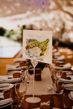 the table is set with wine glasses and place cards