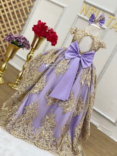 The lavender color, golden lace motifs embroidered on it, the model with the short front and the long back, and the lilac princess dress with the bow on the back manages to make everyone fall in love with it at first sight. It is a perfect fit, especially for people who are tired of ordinary and outdated dress models. This dress, which is specially designed, attracts the attention of princesses. The princesses can dance and play games as they wish, thanks to the fabric that allows them to move f Quincenera Dresses Purple And Gold, Purple Quinceanera Dress With Gold, Lilac Princess Dress, Lilac Party, Purple And Gold Wedding, Lace Motifs, Dresses Handmade, Dress Lavender, Golden Lace