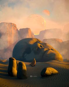 a man sitting on top of a large rock in the middle of a desert