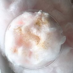 a glass bowl filled with white stuff on top of a table