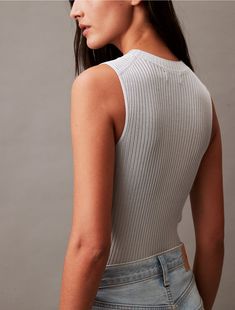 Crafted from high shine viscose with a soft hand feel, this knit sweater tank is a lightweight layering essential. Made with a solid design and sheer styling, a crewneck and side vents at the hem.  Material: 100% Viscose. Chic Ribbed Crew Neck Tank Top, Ribbed Fitted Crew Neck Tank Top, Fitted Ribbed Tank Top With Crew Neck, Fitted Knit Top For Spring Layering, Fine Knit Crew Neck Tank Top For Layering, Fitted Tank Top With Ribbed Crew Neck, Fitted Crew Neck Tank Top With Ribbed Neckline, Elegant Crew Neck Tank Top For Summer, Stretch Crew Neck Tank Top For Fall