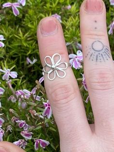 Elevate your style with a sterling silver 'Flower Power Ring' 🌸 - a handcrafted beauty that effortlessly blends simplicity and elegance.  This dainty piece adds a touch of nature-inspired charm to your look, making it a must-have for any jewelry collection. Embrace the grace of petals and embrace timeless sophistication. Handmade to order - please be patient while I make your piece 🔨 🌸 Dainty Adjustable Jewelry For Spring, Dainty Adjustable Toe Ring Jewelry, Dainty Adjustable Spring Jewelry, Adjustable Dainty Toe Ring Jewelry, Adjustable Dainty Spring Jewelry, Nickel Free White Gold Stackable Rings, Nickel-free White Gold Stackable Rings, Delicate Tiny Toe Ring Jewelry, Delicate Toe Ring Jewelry