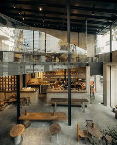 the interior of a building with benches and tables