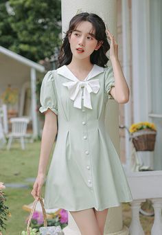 Mini dress with a sailor collar, sweet bow, faux button front, cinched waist and short puff sleeves. Concealed back zipper. S: 13" across shoulders, 32" chest, 25" waist, 31" lengthM: 13.5" across shoulders, 33.5" chest, 26.5" waist, 31" lengthL: 14" across shoulders, 35" chest, 28" waist, 31" lengthXL: 14.5" across shoulders, 36.5" chest, 29.5" waist, 31" length Sailor Collar Dress, Sailor Collar, Shoe Gifts, Overall Dress, Sweater Blouse, Collar Dress, Cardigan Jacket, Cinched Waist, Puff Sleeves