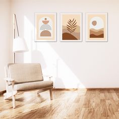 a living room with three pictures on the wall and a chair in front of it