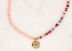 Handcrafted with Love Choker Multicolor Vinyl Disc Beads with 24K Gold-Plated with Smiley Zirconia Pendant Length: 14.5" with 2" Adjustable. Made in Colombia Playful Pink Necklaces For Festivals, Playful Pink Necklace For Festival, Playful Pink Festival Necklaces, Pink Jewelry With Gold Beads For Festival, Pink Gold Beaded Jewelry For Festival, Pink Heishi Beads Necklace For Gift, Pink Letter Beads Jewelry For Festival, Pink Letter Beads Festival Jewelry, Playful Pink Necklace With Colorful Beads