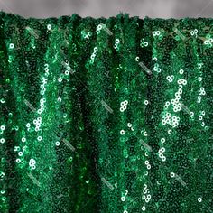 green sequin curtain with white flowers on it