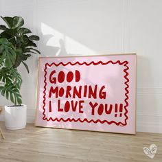 a sign that says, good morning i love you on it next to a potted plant