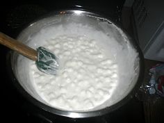 a pan filled with white liquid sitting on top of a stove