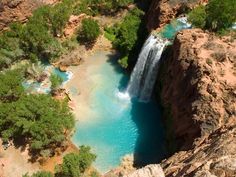 an aerial view of a waterfall in the desert