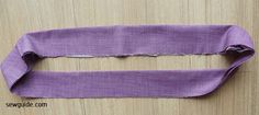 a piece of purple fabric with torn edges