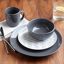 a table set with plates, cups and utensils on top of a wooden table