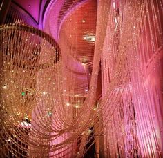 a large chandelier hanging from the ceiling in a room filled with lights and decorations