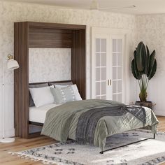 a large bed sitting on top of a wooden floor next to a white wall mounted closet