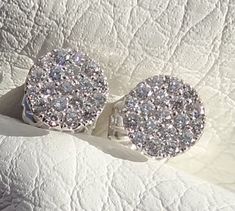 "You will LOVE these little stud earrings. They are classic and chic. They are very petite style earring. The entire earring is 7mm wide in diameter. The diamonds color is beautiful and rich. The earrings are made in 18k white gold. They are 7 mm wide. The posts are 10 mm long. The diamonds total carat weight is aprox. .40cts The friction backs are 14k white gold. The clarity of the diamonds is VS and color G range. The color combination of the bright white of the 18k white gold settings against Pave Setting Cluster Earrings As Gift, Fine Jewelry Cluster Earrings With Pave Setting As Gift, Gift Cluster Earrings With Pave Setting, Luxury Round Cut Cluster Earrings For Anniversary, Luxury Cluster Earrings For Anniversary, Formal White Gold Cluster Earrings Hallmarked, Luxury Diamond Cut Cluster Earrings For Anniversary, Hallmarked Round Cluster Earrings For Anniversary, Luxury Cluster Diamond Earrings For Anniversary