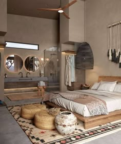 a large bed sitting in the middle of a bedroom next to two round mirrors on the wall