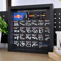 the red bull racing car is displayed in a shadow box