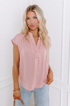 - Add a dash of charm to your closet with this cute top! Perfect for sunny adventures and cozy get-togethers, it effortlessly blends chic style with a bubbly vibe. Get ready to spread some sunshine and feel fabulous in this adorable, must-have piece! - Unlined material - A v-cut neckline with two buttons - Short, loose sleeves - A relaxed silhouette that ends in a curved hemline Chic Vacation Top In Solid Color, Chic Solid Color Top For Vacation, Feminine Solid Color Summer Top, Summer Brunch Top In Solid Color, Solid Color Summer Top For Brunch, Summer Solid Color Top For Brunch, Solid Color Top For Summer Brunch, Feminine Solid Color Blouse For Summer, Feminine Solid Color Summer Blouse