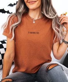 Celebrate Thanksgiving in style with this cozy "Thankful" shirt, perfect for fall family gatherings or showing your gratitude this season. This minimalist design features the word "Thankful" printed on a soft, pumpkin-orange, 100% cotton shirt, making it the ideal blend of comfort and fashion for fall. Crafted from garment-dyed, pre-shrunk US-grown cotton, this unisex tee offers a relaxed fit that's great for casual wear or semi-formal holiday dinners. Whether you're dressing up for Thanksgiving Thanksgiving Outfit Family, Grateful Shirt, Thankful Shirt, Thanksgiving Shirt, Pumpkin Shirt, Family Shirt, Thanksgiving Shirts, Thanksgiving Outfit, Neat Style