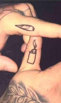 two people with tattoos on their fingers pointing at each other