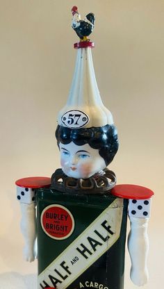 a ceramic figurine with a hat on top of it