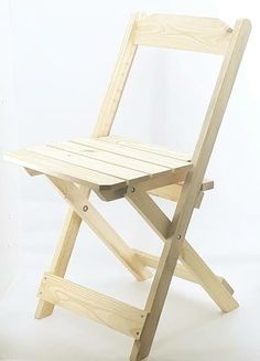 a wooden folding chair sitting on top of a white floor in front of a wall