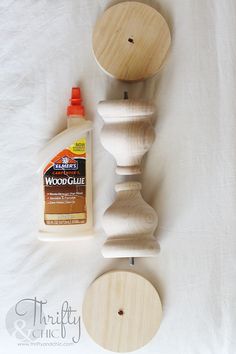 some woodworking supplies are laying out on a white sheet and there is a bottle of wood glue next to it