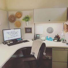 an office cubicle with a computer and chair