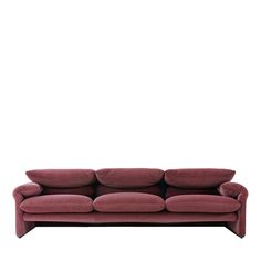 a red couch sitting on top of a white floor