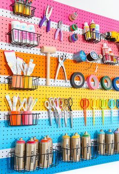 there are many craft supplies on the pegboard in this room and it's colorful