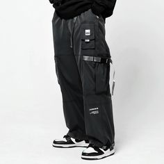 Loose streetwear reinvented: discover our unique baggy joggers. Unveiling the Streetwear Baggy Pants, a daring reinterpretation of classic urban style meticulously tailored for the modern city explorer. Envision the power and confidence you embody as you navigate the dynamic urban landscape, the energy of the city mirroring your own. These oversized, straight-fit cargo pants don't merely boost your daily elegance - they amplify your innate audacity, positioning you at the forefront of contemporary fashion. Adorned in these multifunctional black streetwear joggers, you seamlessly become a part of the city's pulsating heart. The pants' versatility seamlessly matches any streetwear accessory, bestowing you the command over your look, and letting you set the pace of urban fashion trends. Delvi Techwear Parachute Pants With Functional Pockets, Techwear Style Cargo Pants For Streetwear, Techwear Baggy Sweatpants For Streetwear, Baggy Techwear Pants With Cargo Pockets, Techwear Sweatpants With Pockets, Baggy Techwear Sweatpants, Baggy Techwear Pants With Multiple Pockets, Baggy Techwear Sweatpants For Streetwear, Techwear Parachute Pants With Multiple Pockets