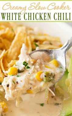 a spoonful of creamy slow cooker white chicken chili on a plate with chips