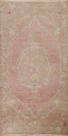 an old, faded rug is shown in pink and beige