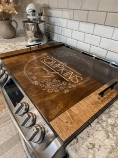 a wooden cutting board sitting on top of an oven